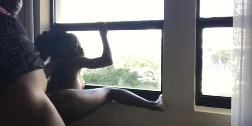 Young black guy doggystyle standing at the window