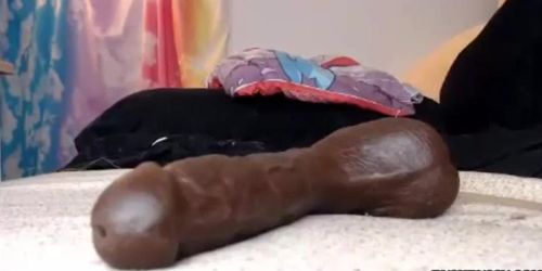 Freckled girl close up sucking massive black dildo