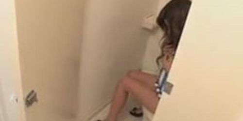 horny brunette masturbates solo in the toilet