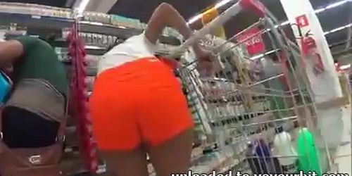 Nice girl with bubble ass in orange shorts