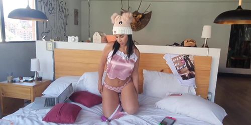 Latina masturbates with a vibrator on a bed