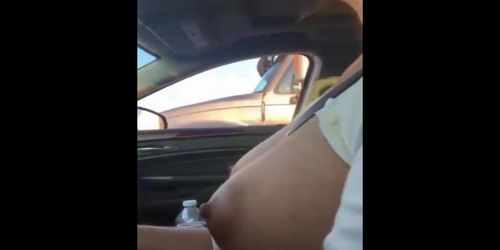 mature woman touches her big boob rolling next to a trucks