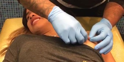 Girl getting her nipples pierced 