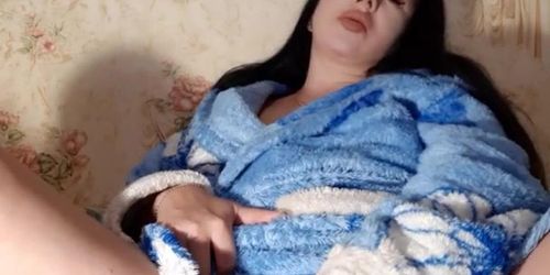 the baby in a home dressing gown is ready to masturbate