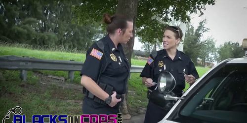 Tattooed cop pleasing black guy