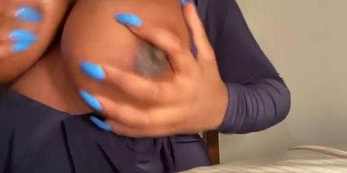 Ebony girl massages her big tits with oil