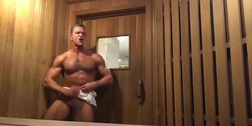 Muscle jock shoots load in public sauna