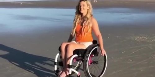 paraplegic wheeling on beach