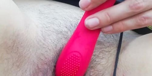 Cumming outside with red toy public outdoors