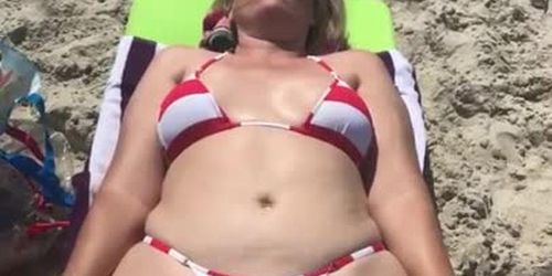 Milf paws wife tanning on the beach