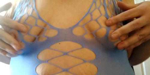 Playing with my rough nipples through blue fishnet feels so good.