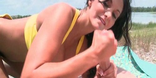 Wild amateur brunette giving an amazing tugjob at the beach