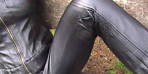 Blonde in leather pants and leather jacket masturbating outdoors