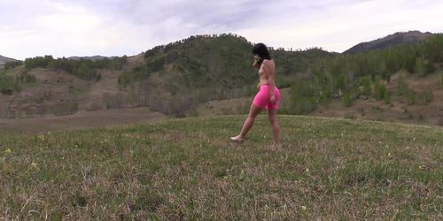 Nudist with a big ass and hairy pussy runs outdoors. Exhibitionism