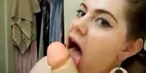 Brunette chick with pigtails sucks big dildo
