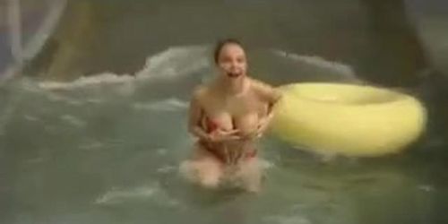 Busty girl's tit pops out while she was going down the waterslide