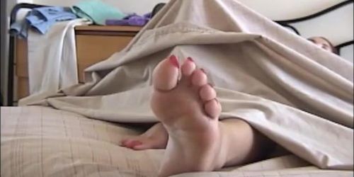 Ebony long toenails in bed lying down