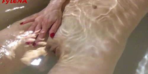 The horny whore masturbates and pees in the tub with water