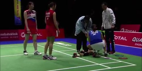 Graceful japanese badminton player foot hurt