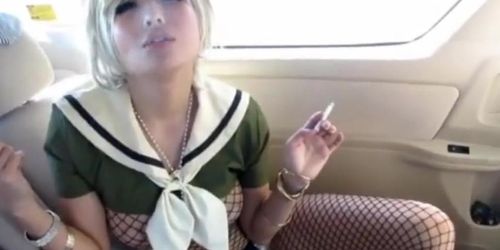 Sexy young blonde Asian girl smoking & playing