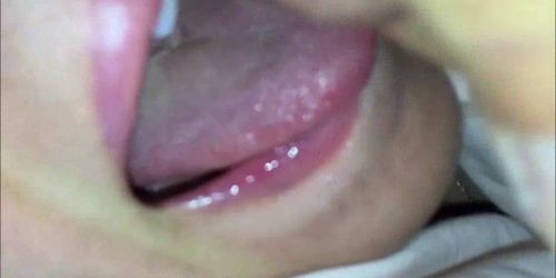 Unloading his cum on her tongue