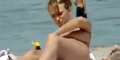 Oiling boobs on topless beach