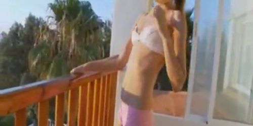 Thin girl teasing and fingering pussy on a balcony