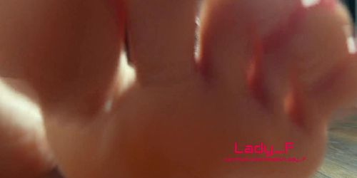 Mistress shows beautiful feet with long toes with red nails, Lady Footfetish soles