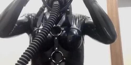 girl in latex wearing gasmask