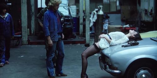 Offering herself to strangers in a garage (vintage flick)