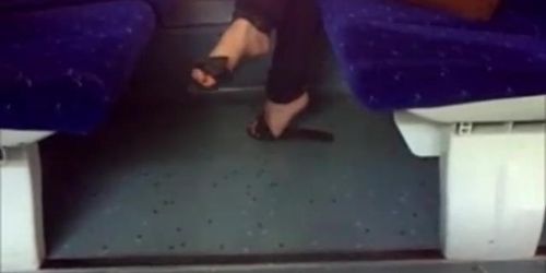 Candid flip flops dangling in train