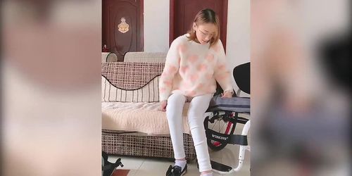 Asian paraplegic woman transfering, playing with dead legs