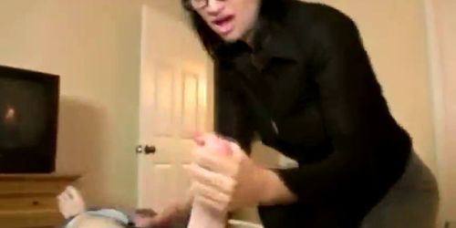 Sexy spex MILF enjoys pulling on a cock