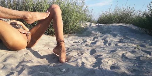 French nudist teen hides at the beach and plays with her tanned petite body