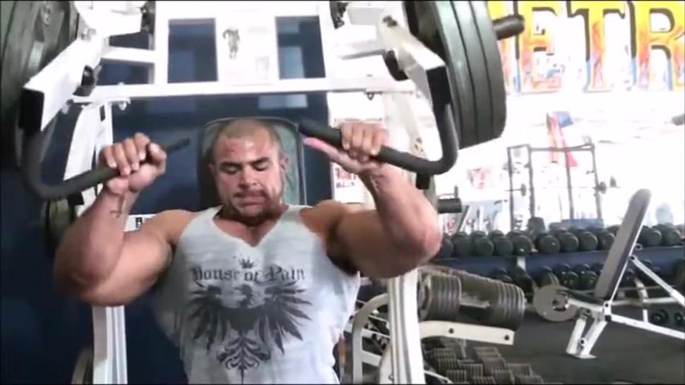 Sexy sweaty bodybuilder flexing biceps with hairy armpits