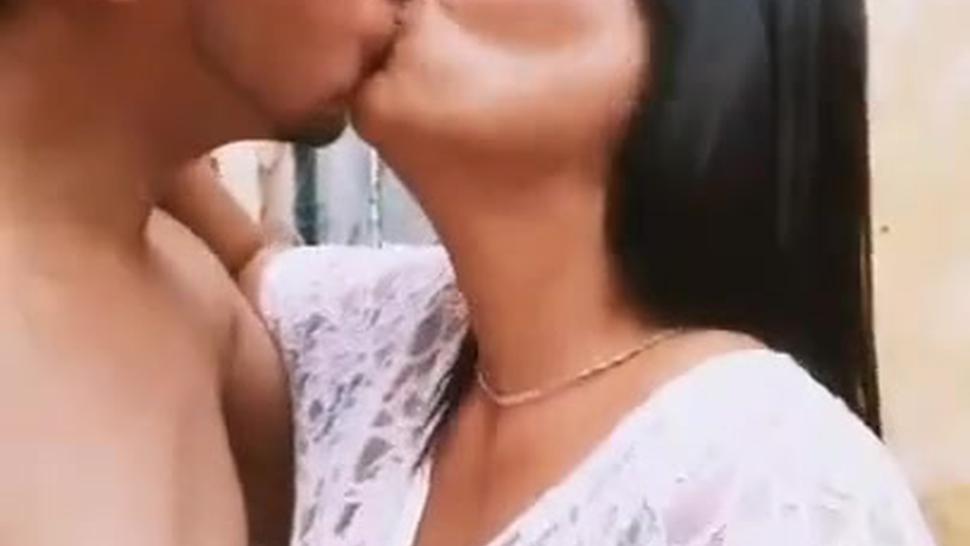 Mature woman  kissing young man