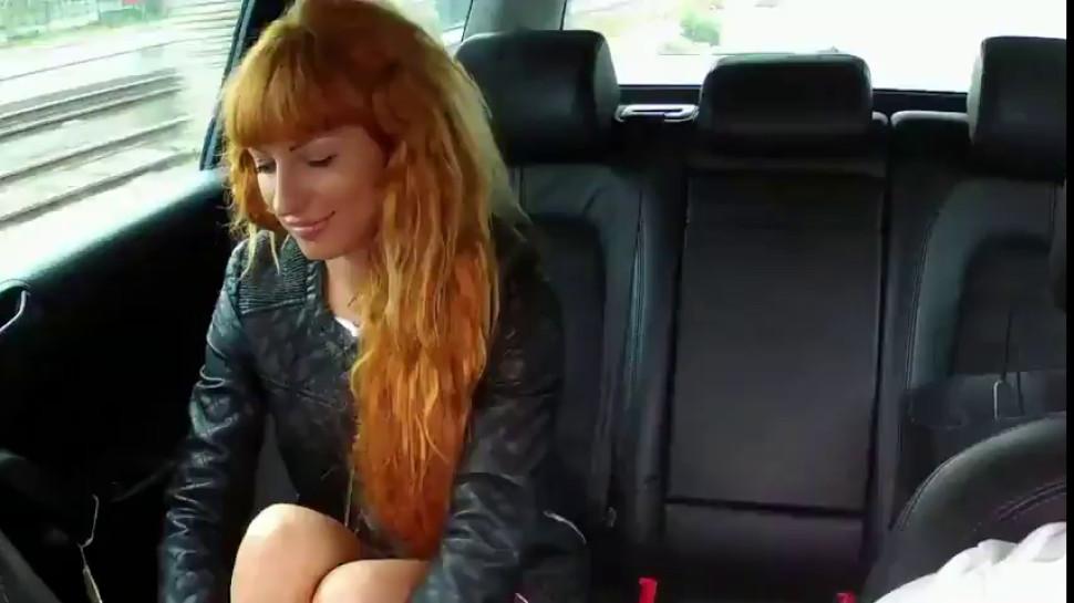 Redhead masturbates and fucks in fake taxi