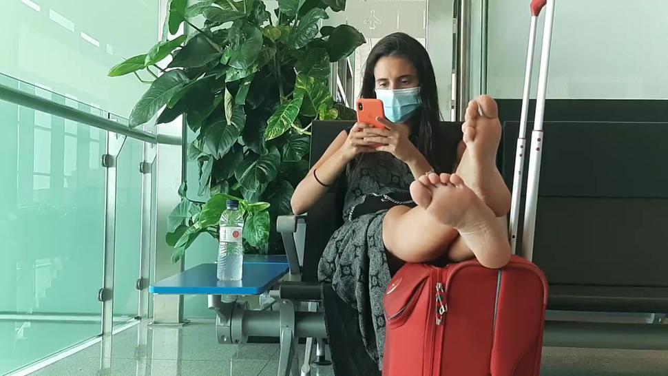 Girl hot soles feet legs in airport barcelona with mask