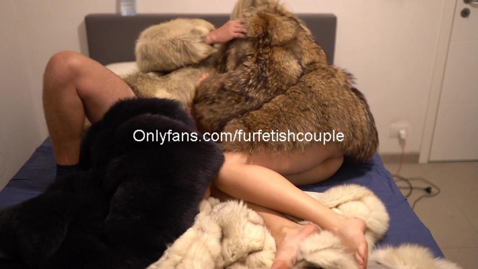 Fur fetish couple kising and cuddling in fur coats