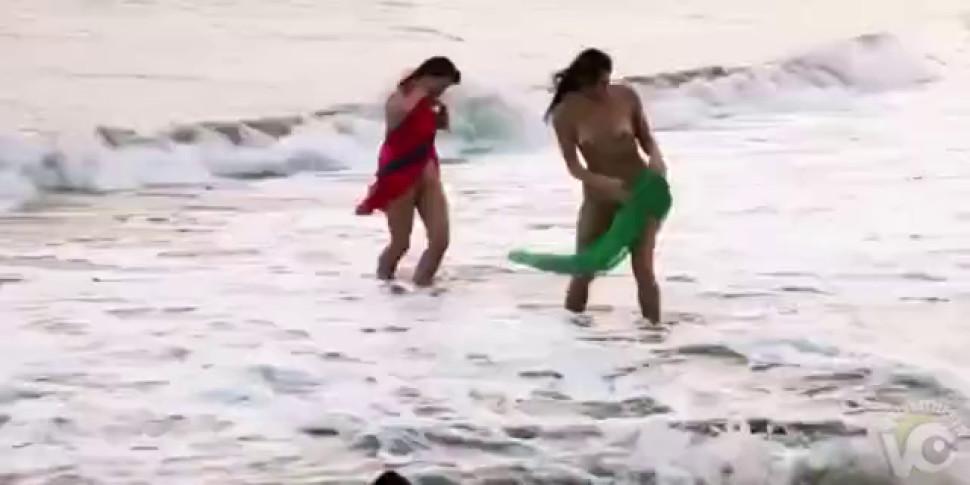 Women bathing naked on the seashore