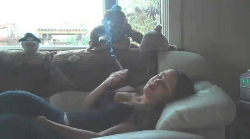 Young girl smoking in the couch