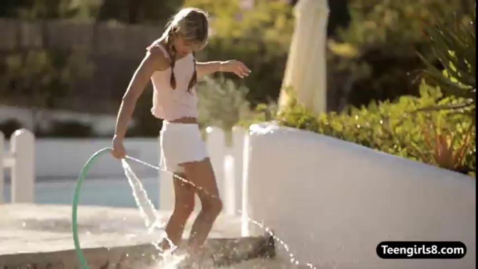 Tiny teen blonde Gina plays with a waterhose outdoor - video 1