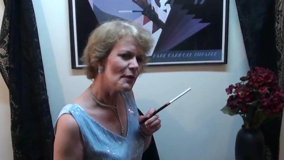 Cultured mature lady smokes with cigarette holder