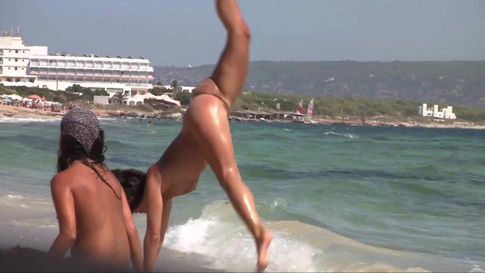 Nude Beach Naked Gymnastics (horny slut finds a fun way to flash her spread pussy to her friends)