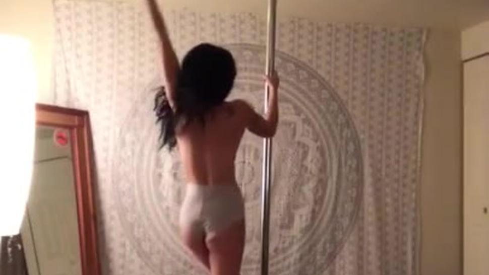 Pole dancing topless at home
