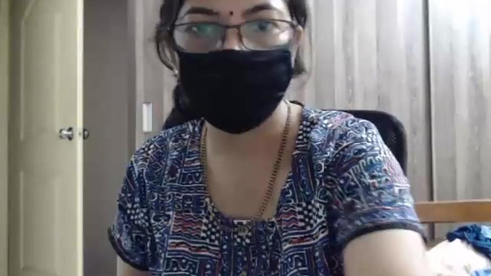 Masked Indian MILF with glasses poses naked on webcam
