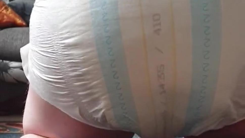Boy messes his diaper while playing