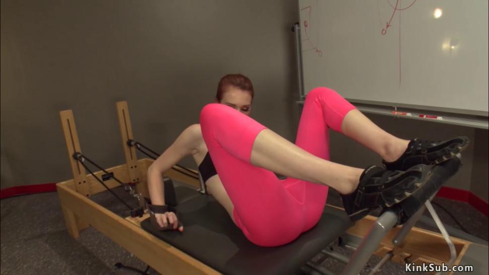 Redhead is machine fucked in gym