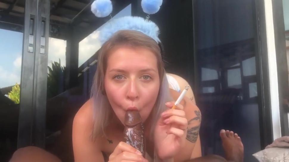 Sexy young blonde girl giving smoking blowjob