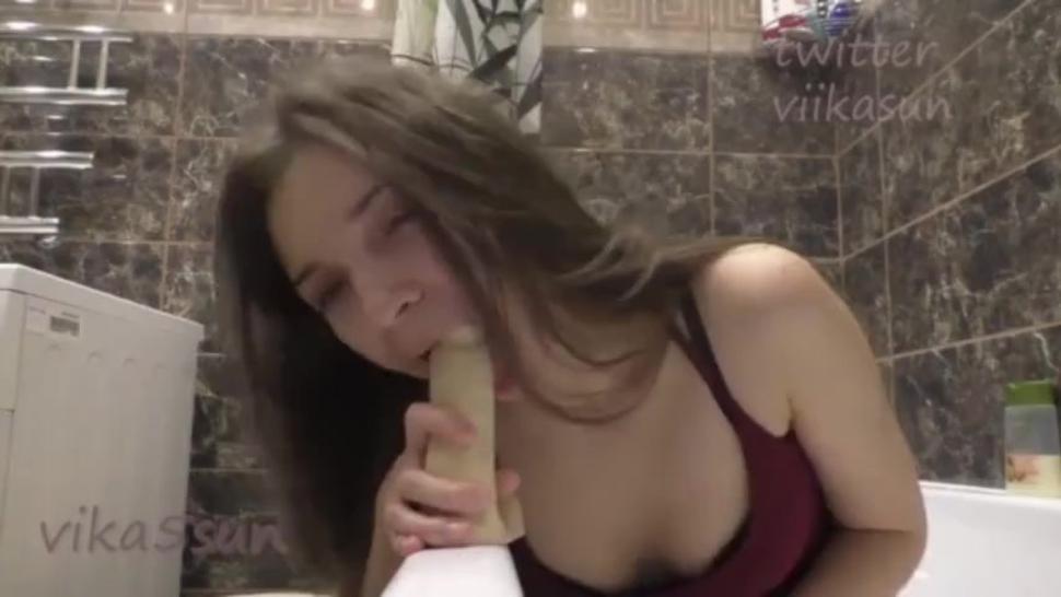 Teen sucks a dildo in her parents bathroom then rides it until she cums